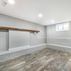 Renovated basement with a pet shower and tiled flooring