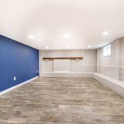 Renovated basement with a pet shower and tiled flooring