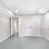 Renovated basement with a pet shower and tiled flooring