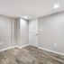 Renovated basement with a pet shower and tiled flooring