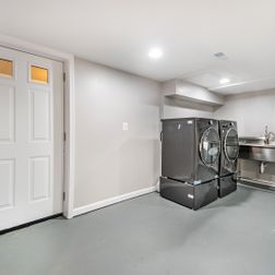 Renovated basement with a pet shower and tiled flooring