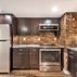 Finished Basement with a kitchen and exposed brick walls., Washington, DC